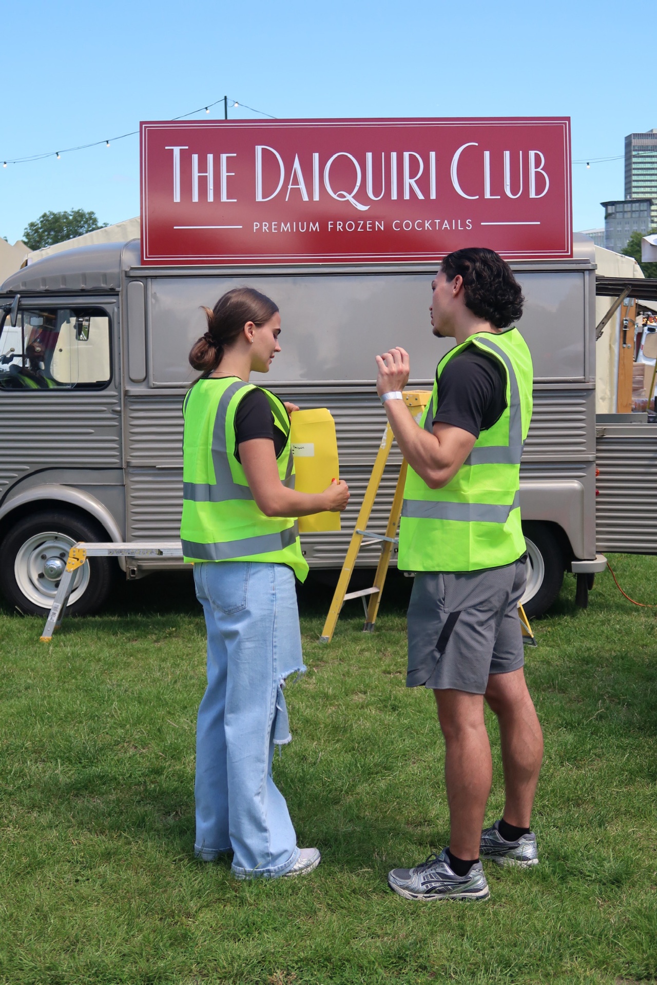 Crew in hi-vis setting up in front of The Daiquiri Club van