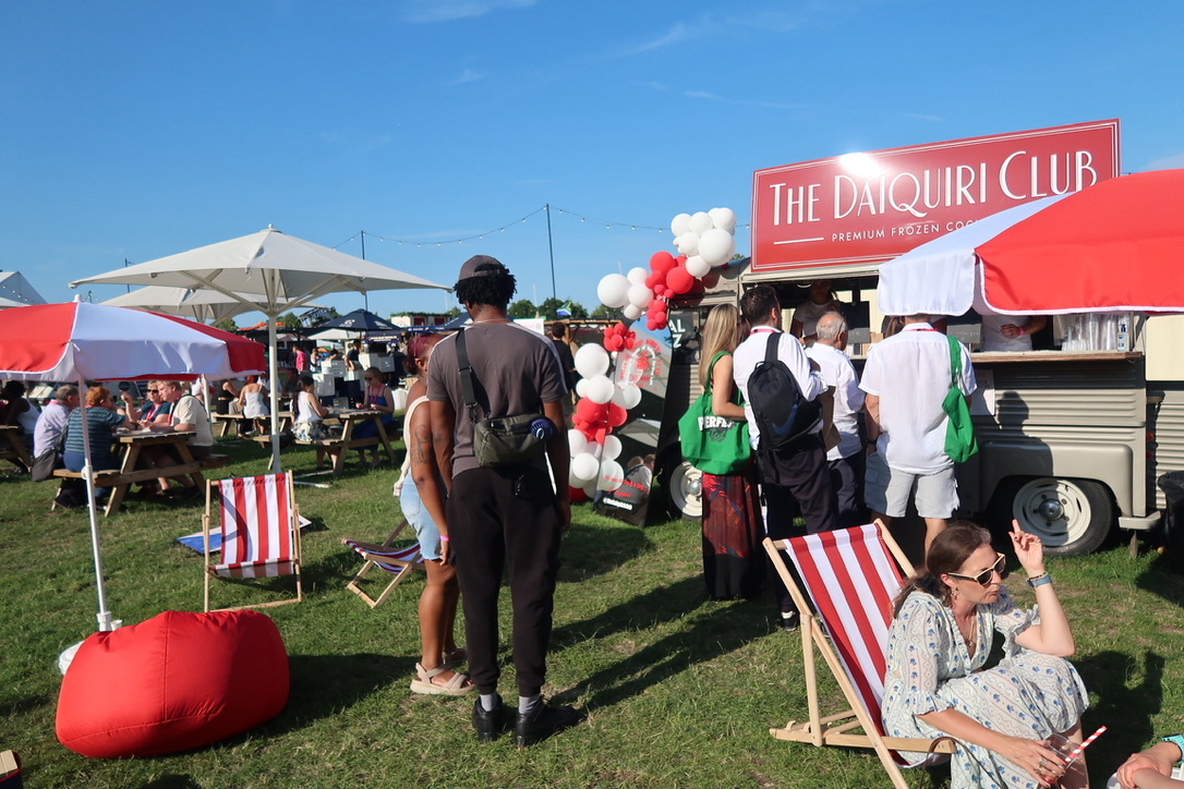 Crowd gathered at The Daiquiri Club van at a festival